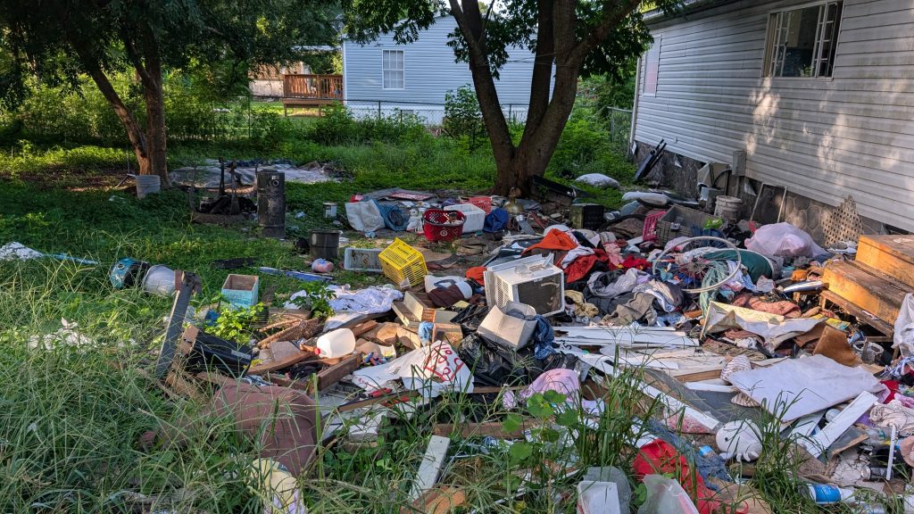 Trash in squatters back yard