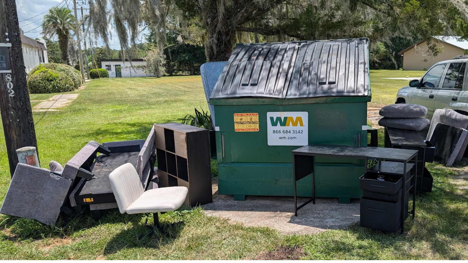 Junk around dumpster